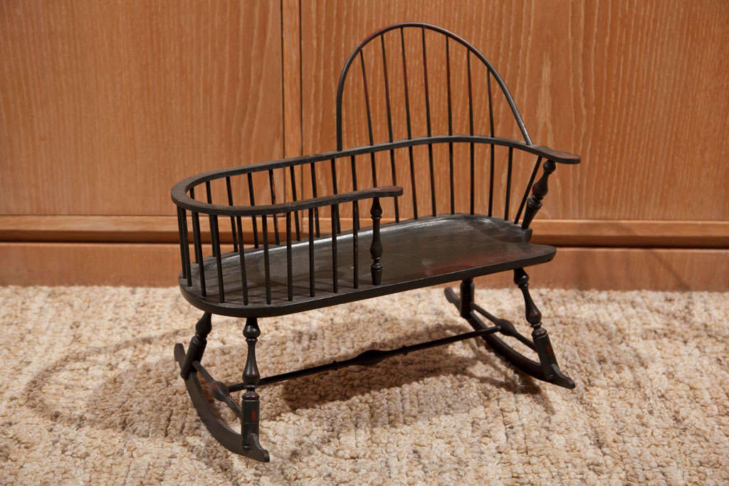 HAND MADE MINIATURE  MOTHER AND INFANT  ROCKER- BABY IS PUT IN CRIB LIKE EXTENSION WHILE MOTHER ROCKS. WINDSOR STYLE. WORN THRU PAINT. MADE BY RIVERBEND CHAIR CO.  WESTCHESTER, OHIO