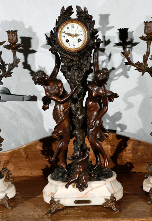 A large and imposing French, 19th century, figural three piece clock set having a pair of five light candelabra. All elements stand on shaped white marble bases raised on splayed feet. This ensemble will add interest and become the focal point in