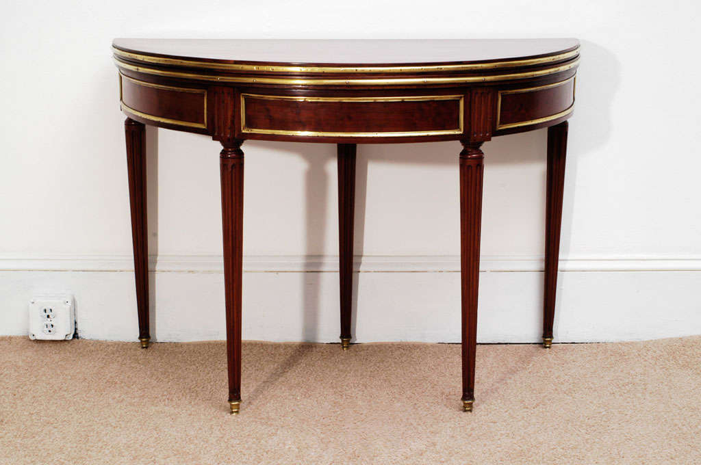 This games or card table is a Louis XVI classic design with original ormolu trim, reeded legs and a hidden back drawer (great place for cards or secret love letters). The flip side of the top (playing surface) had the rotten remains of old gaming