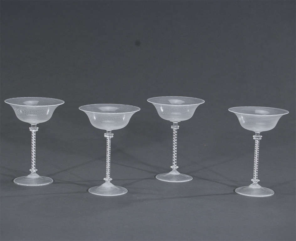 This wonderful set of 4 goblets exhibit a white and clear finely threaded bowl with a complimentary 