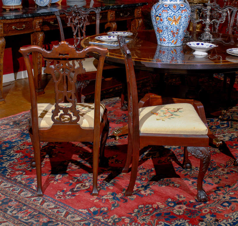 Georgian style carved mahogany ribbon-back dining chairs, set of eight late 19th/early 20th century, comprised of six side and two armchairs, shaped crestrail with acanthus-leaf medallion above pierced ribbon splat leading to needlepoint slipseat