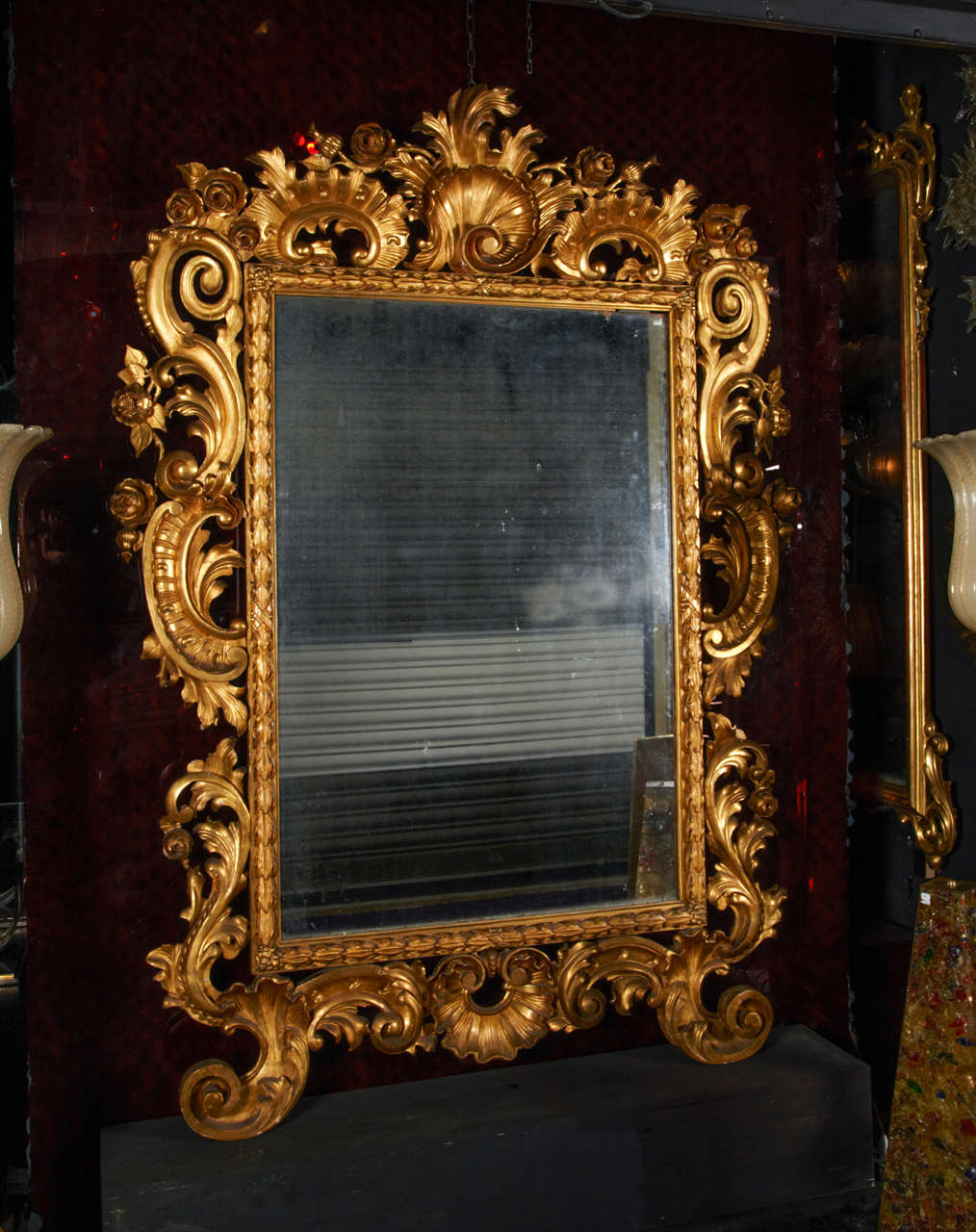 Exceptional mid 19th century huge Italian Baroque mirror.  The frame is in original gilt carved wood.  Perfect condition.  The mirror original too.