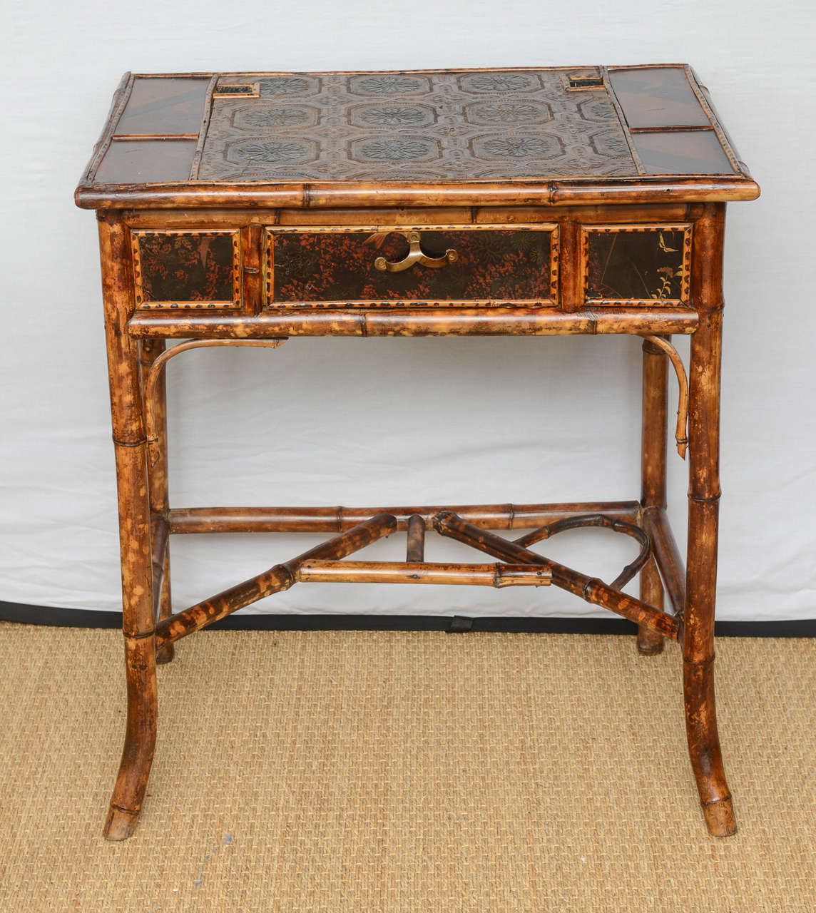 A Victorian English bamboo writing table with inkwells and leather paper on top (all original).