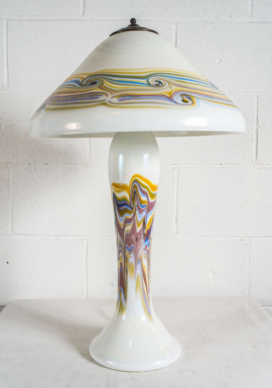 Here is a unique swirled glass lamp with glass shade in a Tiffany style.