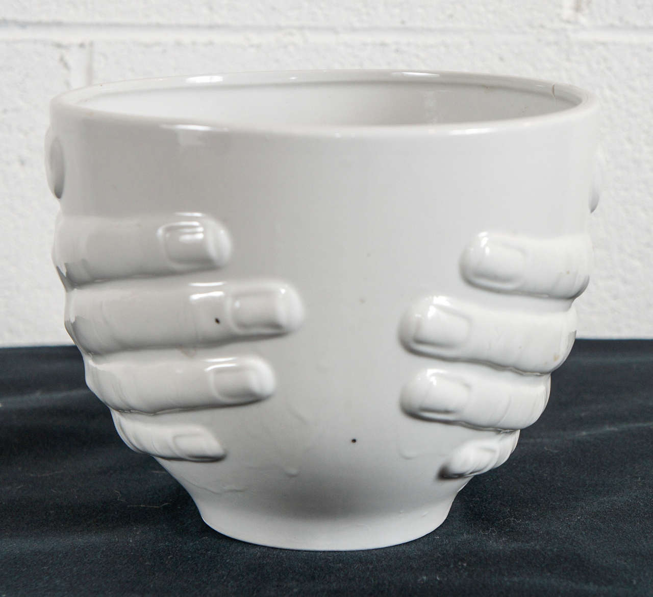 Here is a porcelain bowl held by two hands.
