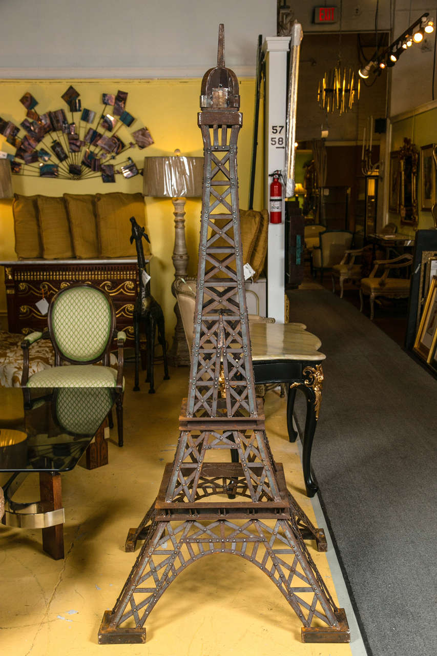 A finely detailed six foot tall Eiffel Tower sculpture. Steel and wrought iron welded tower replica. Having the form and appearance of the Eiffel Tower.