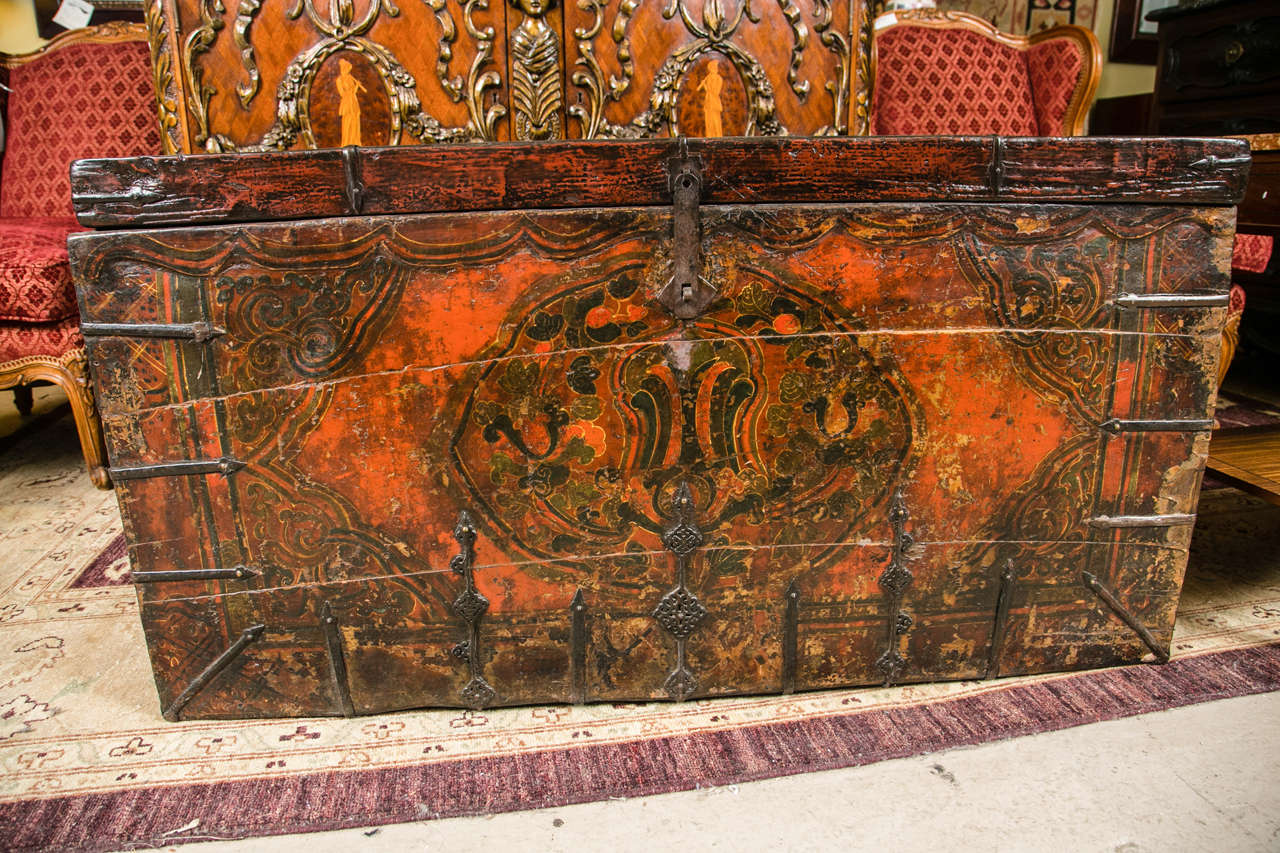 A fine antique dowry chest or trunk. Chinese depicting an Asian scene. The overall truck case supported by metal brackets on the sides and bottom with old metal hinges.