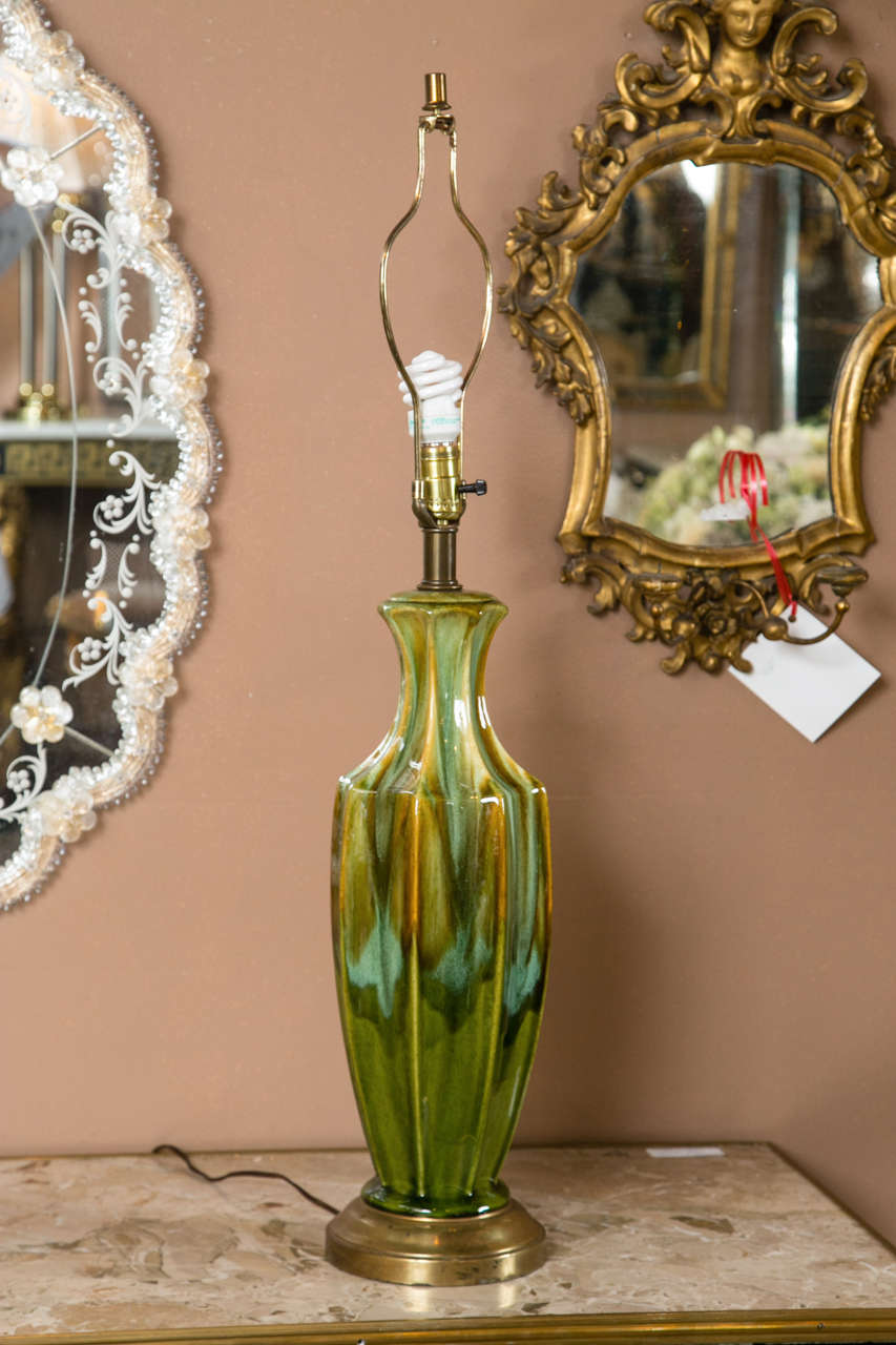 A pair of Art Deco style lamps. The magnificent green Murano Glass is indeed a beautiful representation of a period where the collective of artistic vision created experimental and avant-garde design. The color is embellished with a robin's egg blue