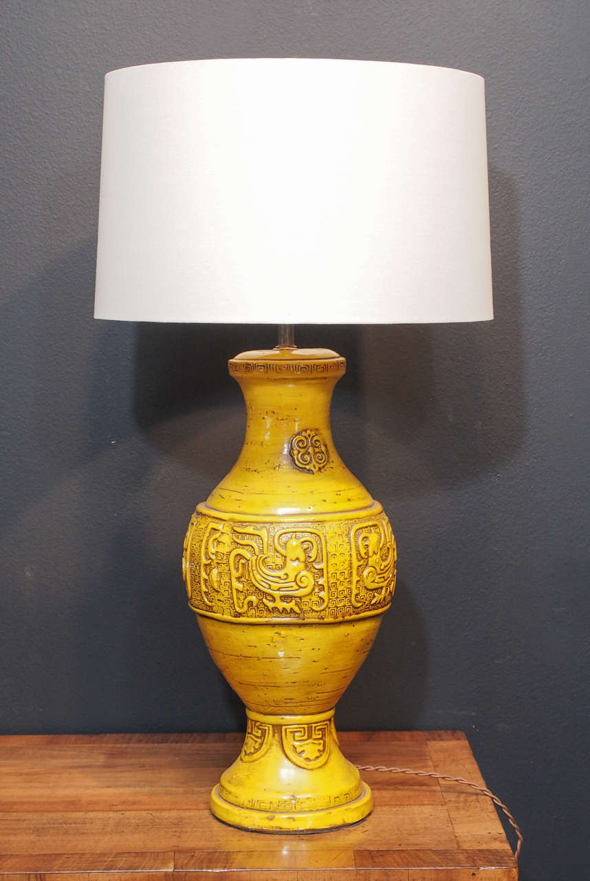 Pair of deep yellow ceramic lamps with intricate tribal design detail. Height to top of socket 24