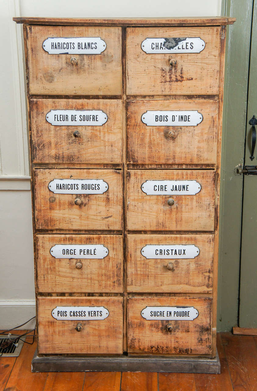 What a find this was. A seed cabinet from a French florist in the South of France. How rare it is to find one with original porcelain labels, some worn away. There can't be a better more useful and unique piece at the same time. We are overjoyed