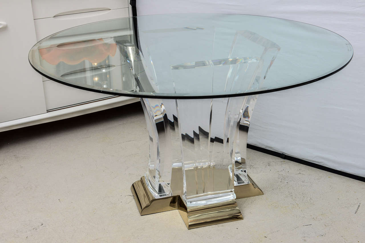 Lucite and light brass Art Deco style dining table by Jeffrey Bigelow. The table may be used as a center table or dining table. The current circular glass is 54 inches in diameter.