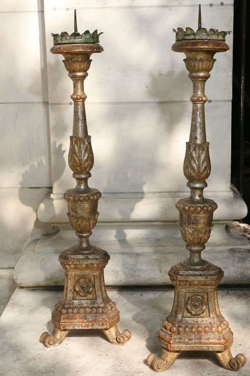 This large and impressive pair of silver gilt and carved wood altar sticks retain great color and patina. They are either French or Italian (the red underground color is used in both countries though less often in France) and the rub thrus add a