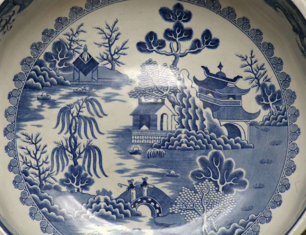 A perfect focus piece for a table top or country kitchen counter. The scene is a variant of the blue willow pattern after the Chinese. Sometimes referred to as transfer ware because of the way the decoration is applied