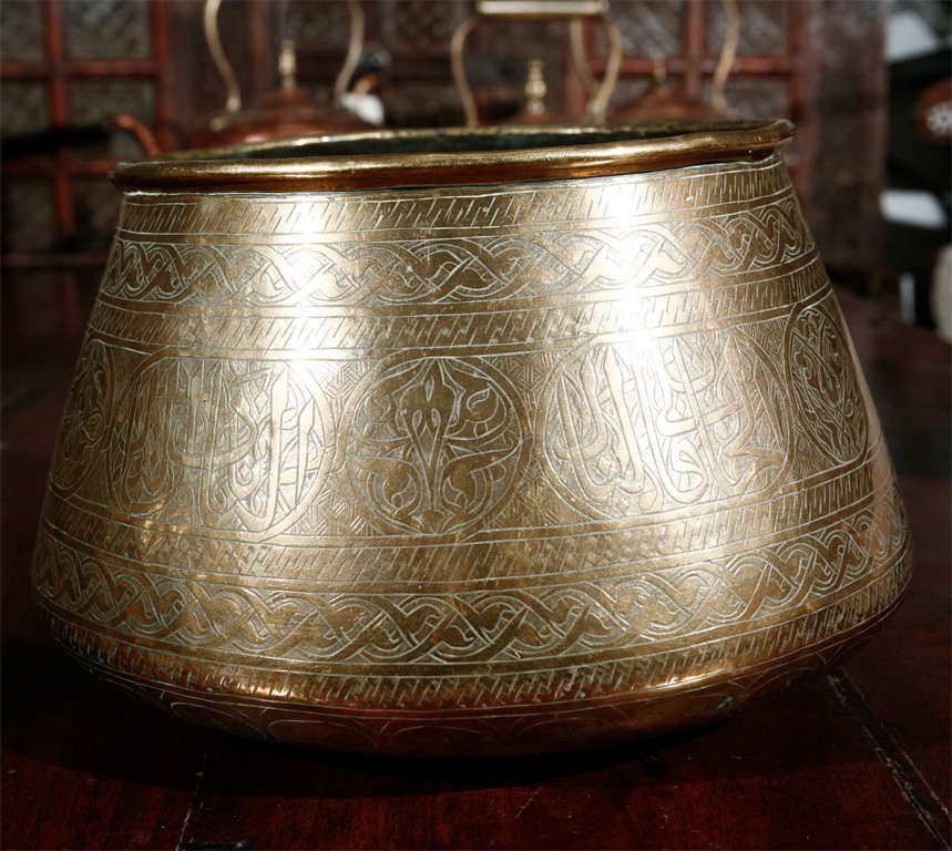 Persian Hand Etched Mamluk Brass Bowl.
Could be used as a Jardiniere.
Arabic Islamic calligraphy and geometric designs on brass vessel.Probably Syrian or Persian.
Miiddle Eastern Origins.

Mosaik provides Antiques,Art Deco, Moorish Style,