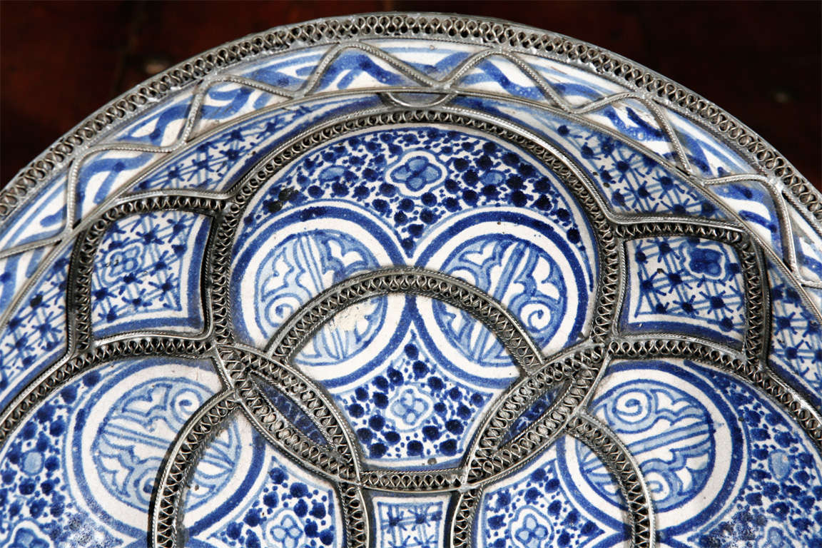 Handcrafted Moroccan Ceramic Plate from Fez.
Blue de Fez with white designs with nickel silver filigree designs.

Mosaik provides Antiques,Art Deco, Moorish Style, Spanish, African, Islamic Art, Arabian, Middle Eastern, Egyptian, Syrian