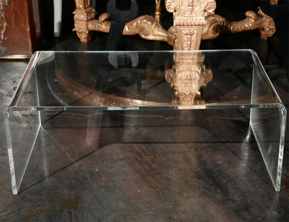 A simple and elegant Lucite waterfall coffee table.