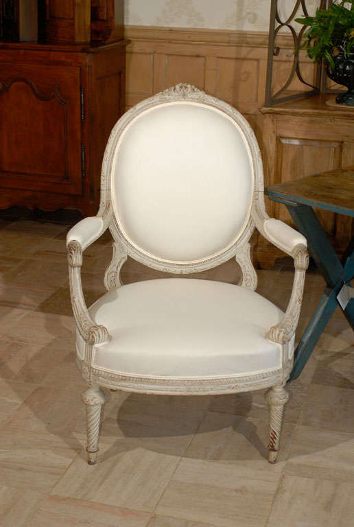 19th Century French Grey Painted Louis XVI style Chair, Circa 1880
This is a larger than normal Louis XVI armchair, which makes it very comfortable.  The painted finish has a good patina with some wood showing through. The carving is of excellent