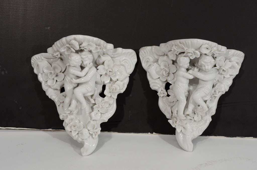 Two Porcelain Wall Shelves with Affectionate Cherubs