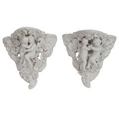 Two Porcelain Wall Shelves with Affectionate Cherubs