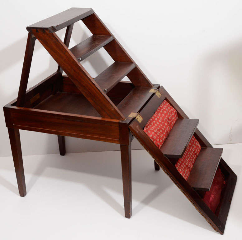 Mahogany fold out steps and upholstered steps create a compact, durable, library steps.