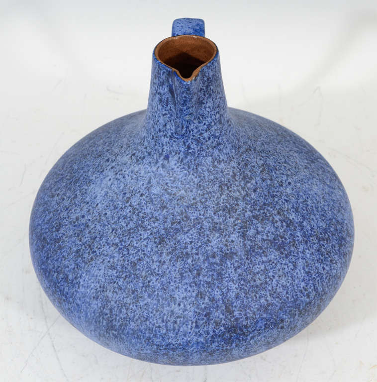 A vintage decanter form ceramic vase with handle with a speckled blue matte glaze. The piece is by Ceramano Germany from their 