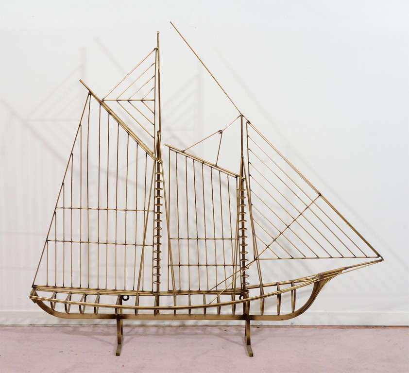A large brass standing sculpture of a ship with open sails. The piece is signed and dated on the hull. age appropriate patina; wire that attaches at the topmost point of the sail has unattached but is still secure (see images 1 and 2)

Reduced