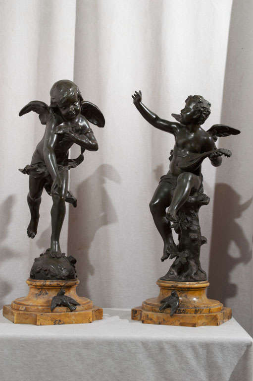 These highly detailed, beautifully patinated cherubs can really bring warmth to any setting.  They are both mounted on their original sienna marble bases.  Note the bird attached to the marble for a more dramatic effect.  While they are a pair, one