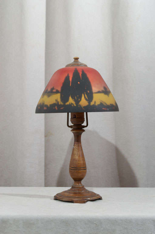 This very colorful little reverse painted boudoir lamp was done by the Moe Bridges Company.  The base is properly signed and the shade is guaranteed to be by the same company.  This little cutie can really make a nice statement in a niche.