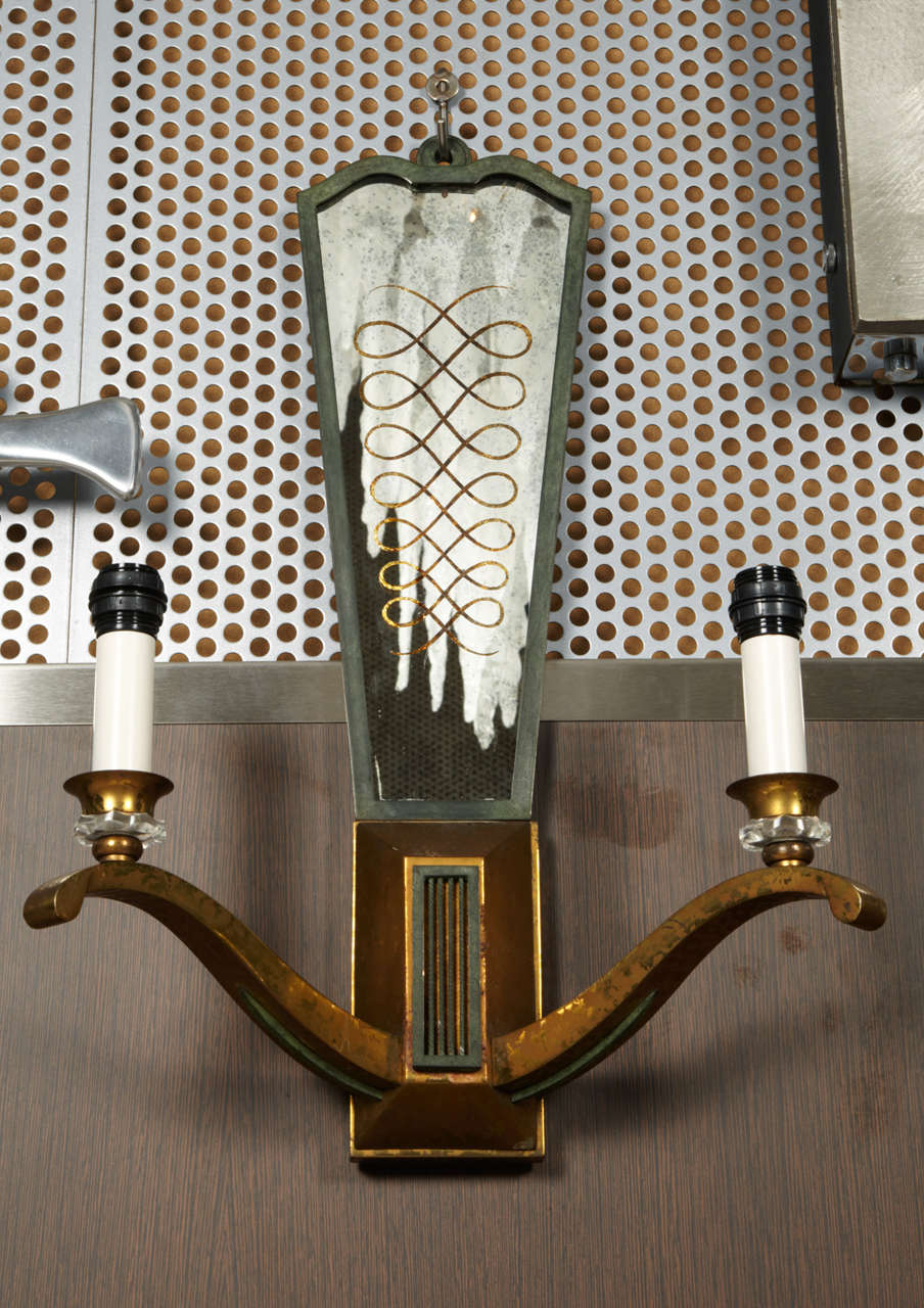 Pair of sconces in mirror and bronze.