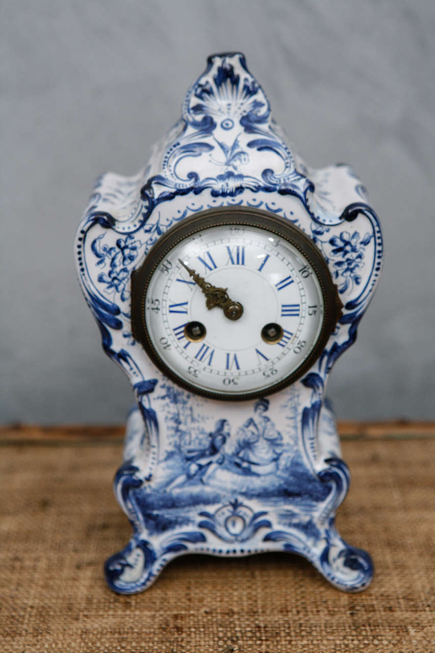 Decorated with figures, flowers and seascapes in a deep blue, this baroque style, key wound, footed shelf clock has a French "Medalle De Argent" movement and strikes on the hour and half hour.



