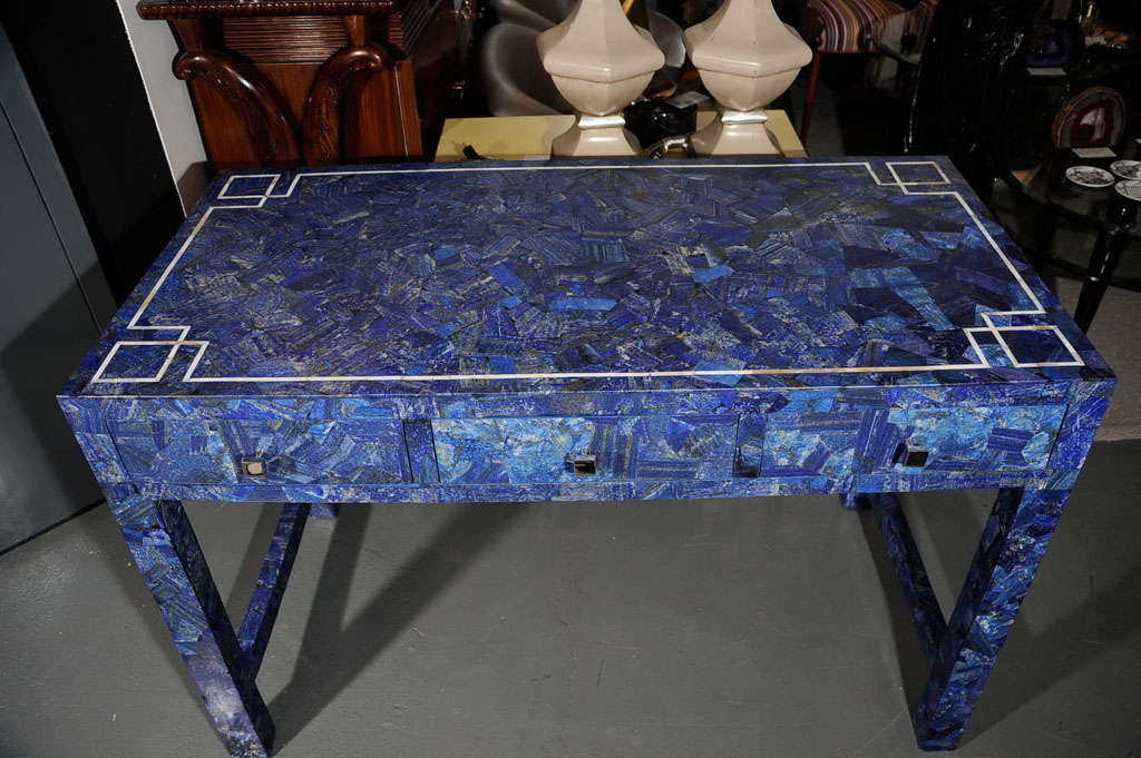 Exceptional Lapis clad desk or console with Mother of Pearl inlay on top. Desk features 3 drawers with square polished nickel pulls. Desk/Console is also clad in Lapis Lazuli on back.