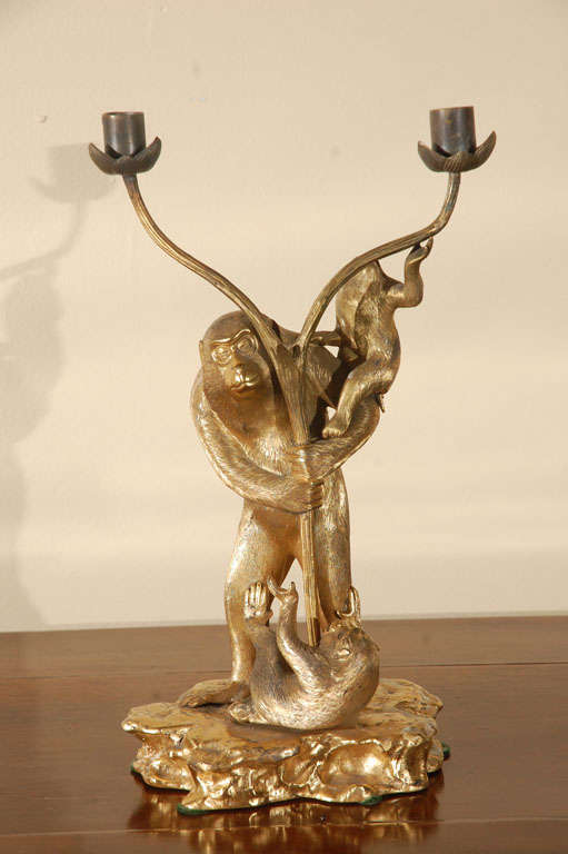 Hand-gilded, bronze candlestick featuring monkeys at play.