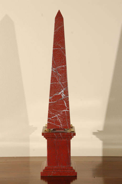 Elegant pair of rouge marble obelisks supported by a base of four gilded bronze turtles.