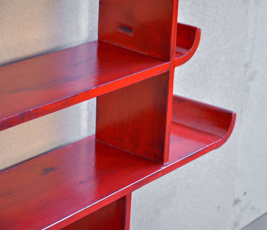 Bookshelf in the style of Gio Ponti, lacquered in red in a later time