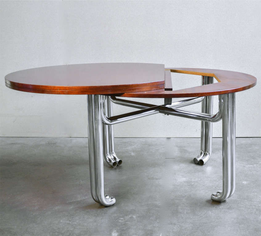 Very nice adjustable teak wood table. Becomes oval when open.