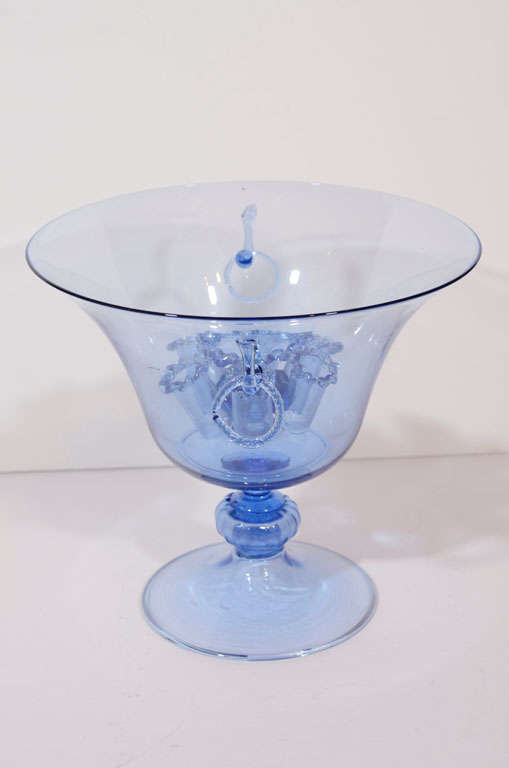 A pale blue footed bowl with a removable frog for flower arranging.