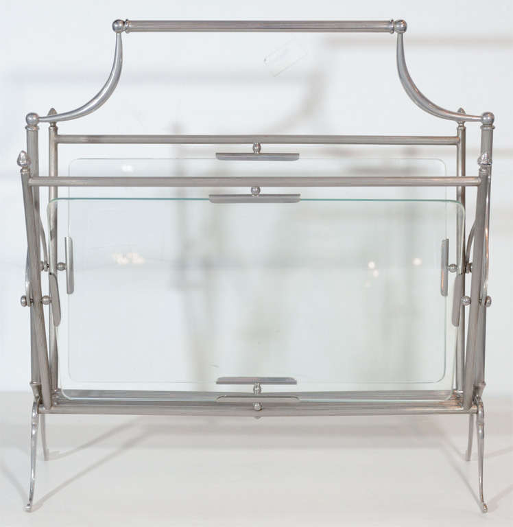 Exquisite magazine stand with a timeless design fitted with the perfect antique nickel accents and glass sides.  In the manner of Adnet.