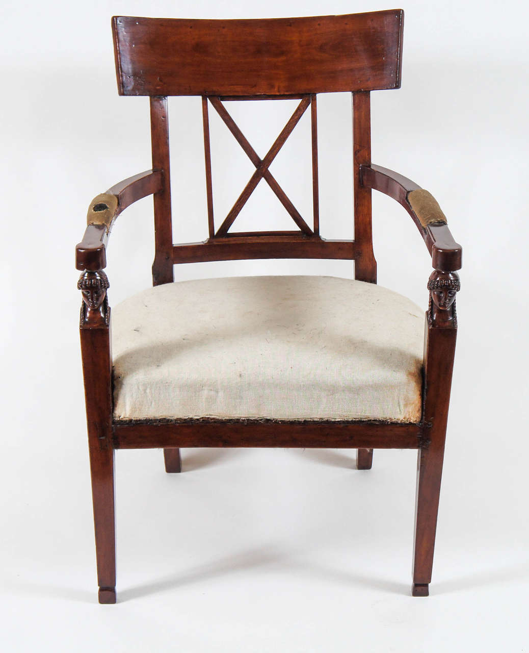 Elegant Italian, French Consulate style and period carved walnut fauteuil having Klismos style tablet form backrest above central X-form open splat, arms with padded rests terminating atop female bust term form front supports with gently splayed