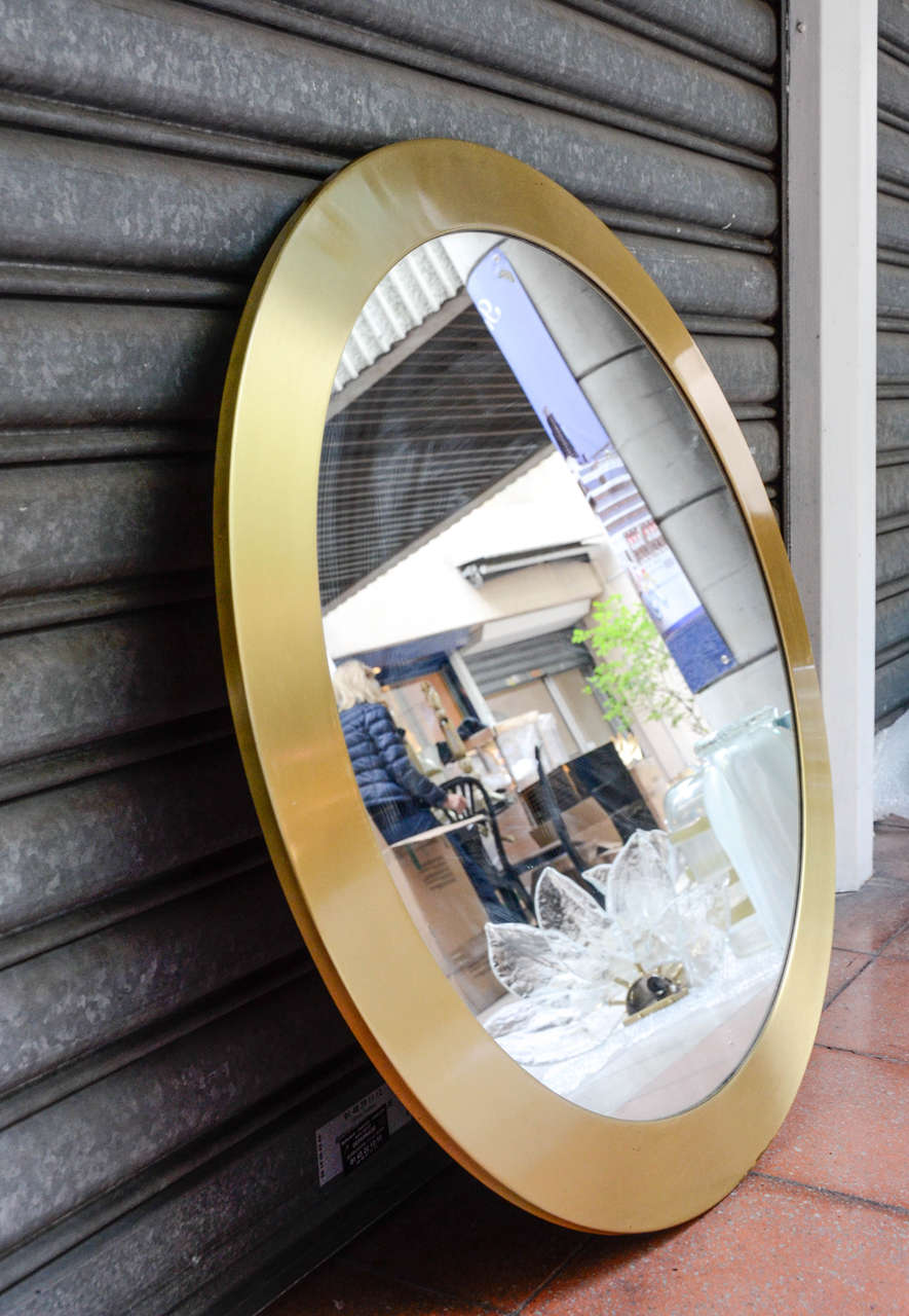 Round mirror surrounded with brass.