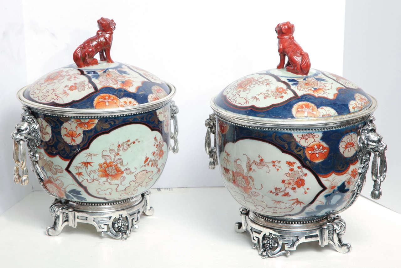 Unusual pair of Imari porcelain and silvered bronze covered bowl centerpieces with seated foo dogs on top made for the oriental market with lion mask face handles.
Stock Number: PP42