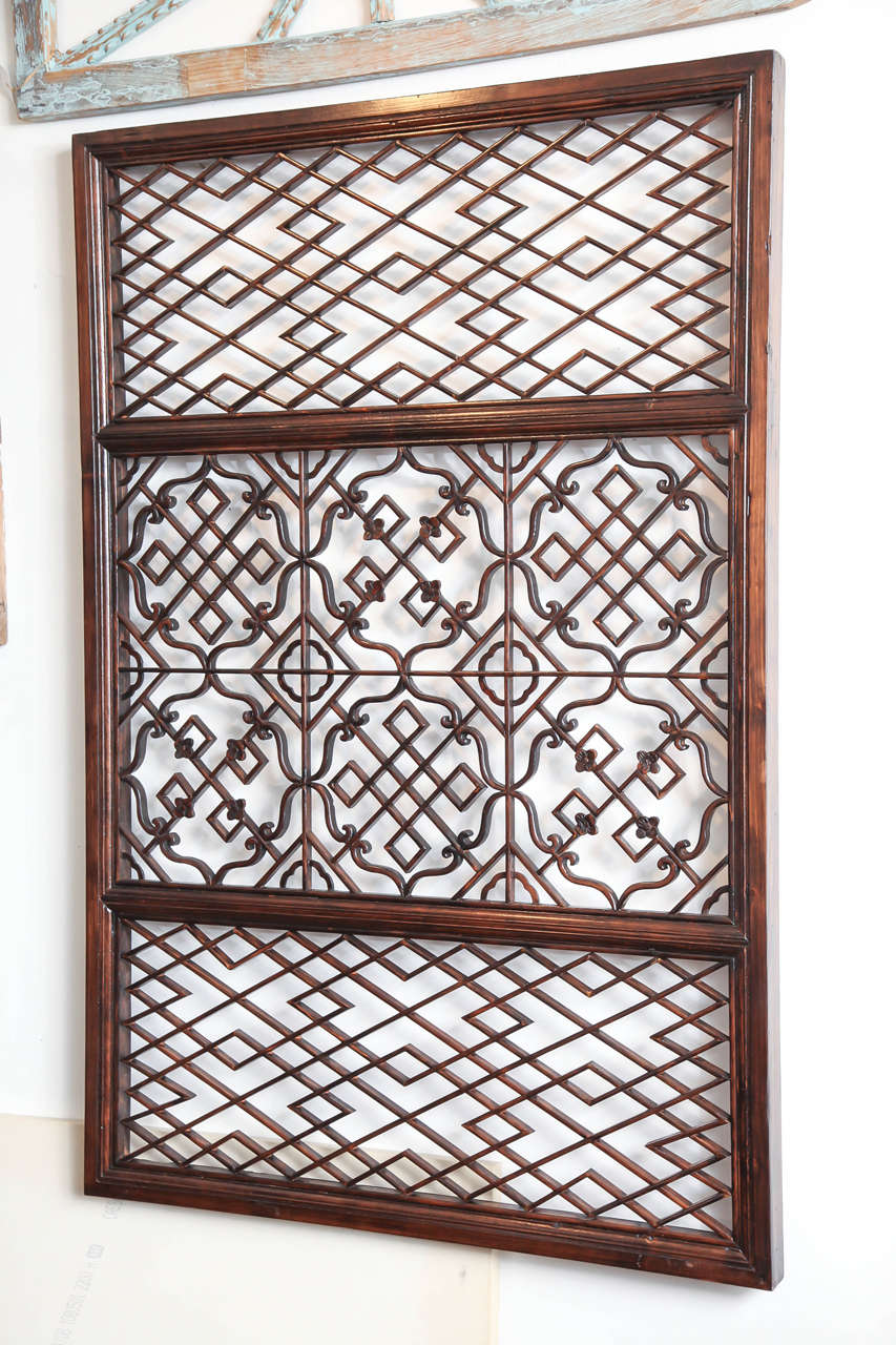 A large lattice screen panel with carved accents and scroll work in center section. From Zhejiang, China, late 19th century. Highly suitable for mirror backing.