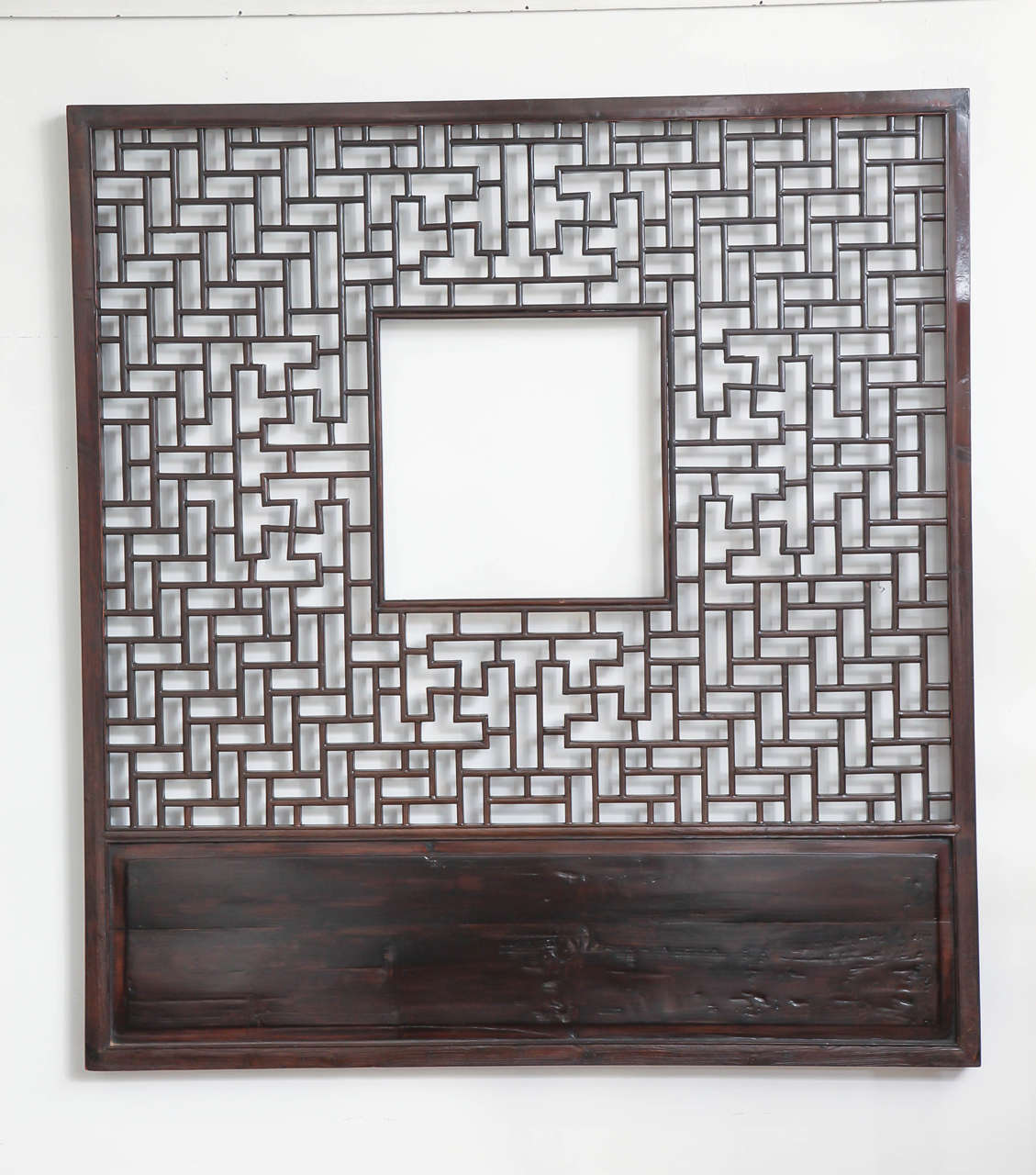 A lattice screen panel from Zhejiang, China, late 19th century. Open square center, solid panel along base.