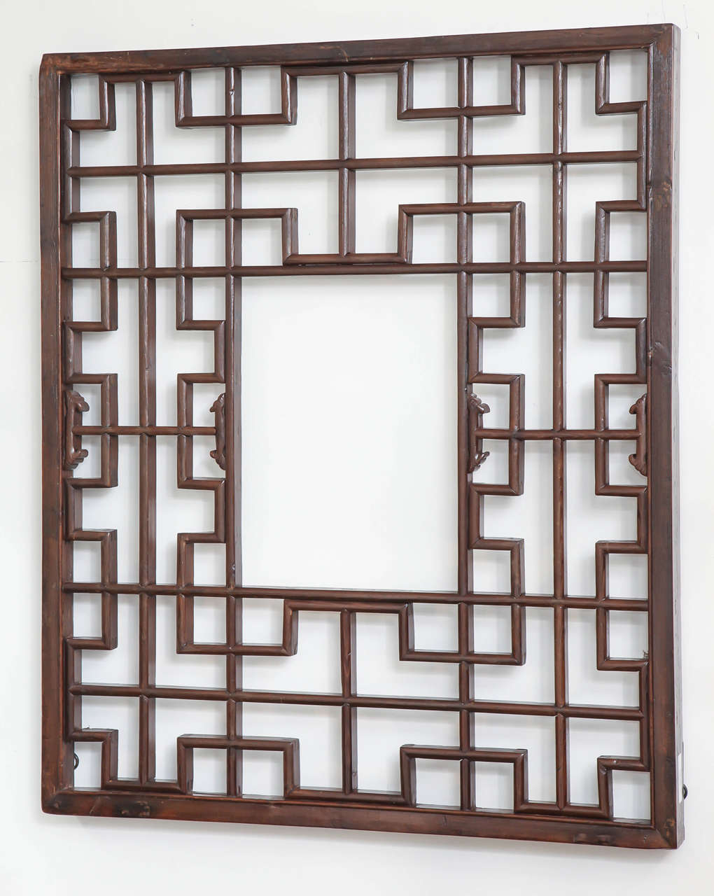 A lattice screen panel with carved details and rectangular opening, from Shanxi, China, late 19th century. Suitable for mirror backing.