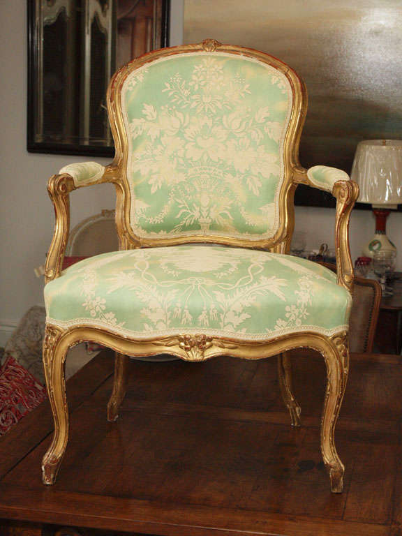 Gilt wood Louis XV Fauteuil newly upholstered in vintage Fortuny fabric.  Fortuny fabric is in green and off white.