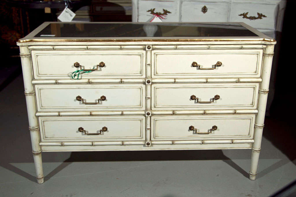 Hollywood Regency Style Silver Leaf Glass Top Faux Bamboo Dresser Chest Commode. A white painted and parcel-gilt faux bamboo dresser, circa 1960, the silver-leafed glass top over a conforming case fitted with six drawers.
