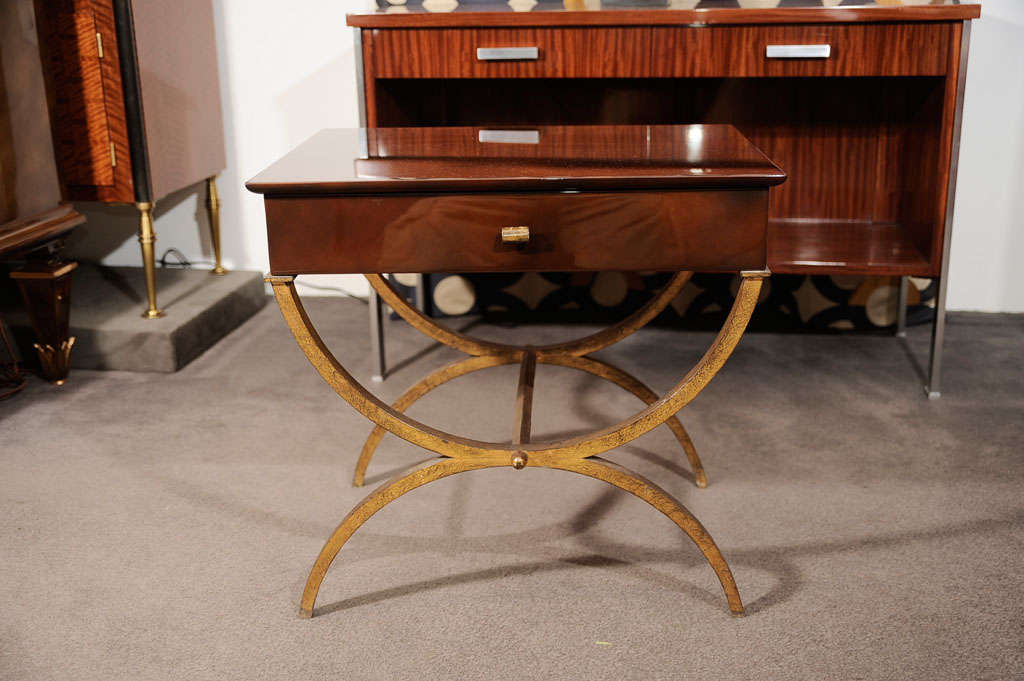 Brown lacquered side-table attributed to Ramsay<br />
on gilt-bronze stand with gilt-bronze ornaments and sycamore interior.