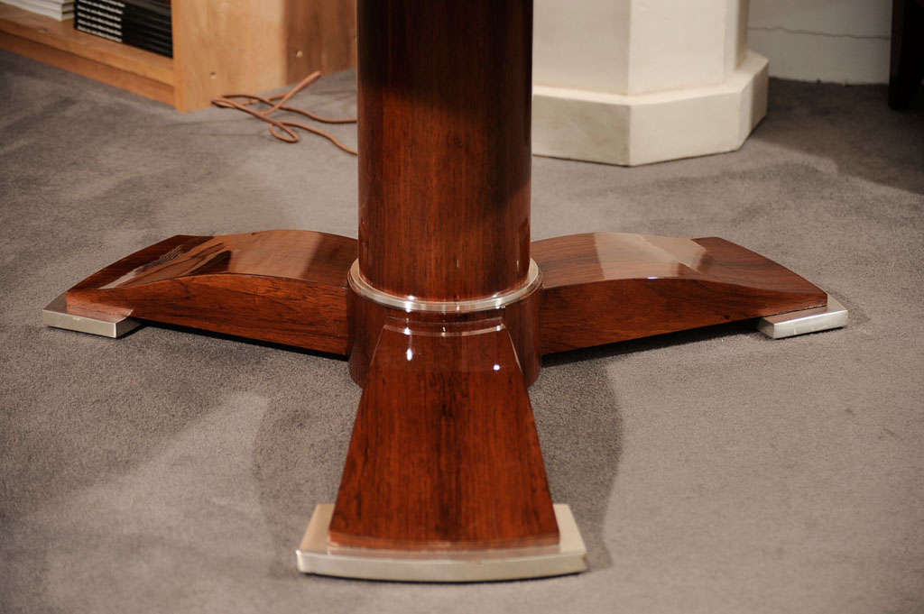 Fine and rare mahogany coffee table by Jules Leleu with a lacquered top, likely by Pierre Dunand, and nickel-plated bronze feet.

A similar table is illustrated in a photograph from the Leleu archives