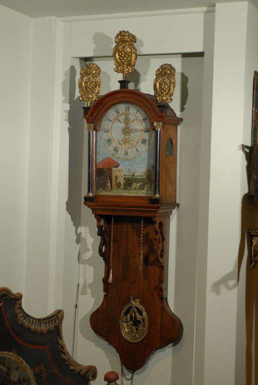 Friesland (Dutch) Wall Clock decorated with hand painted dial of a farm scene and mechanized figures. Additional 3 elaborate cast-lead fretwork can be added to the top.