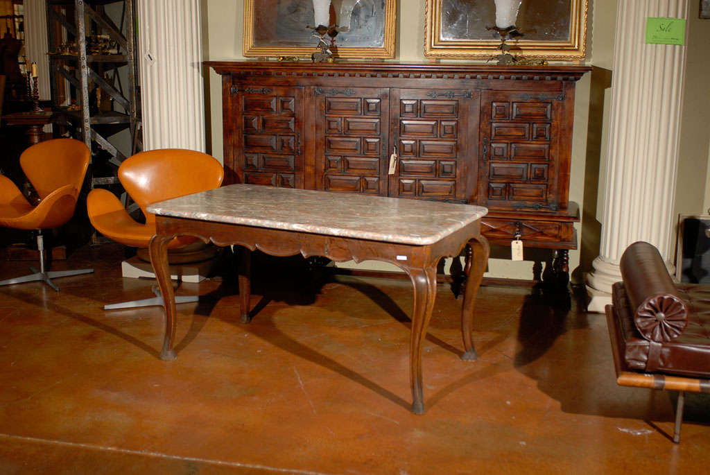 the 18th century French Walnut Hunt Table has hand carved cabriole legs and a marble top.  This is a table 