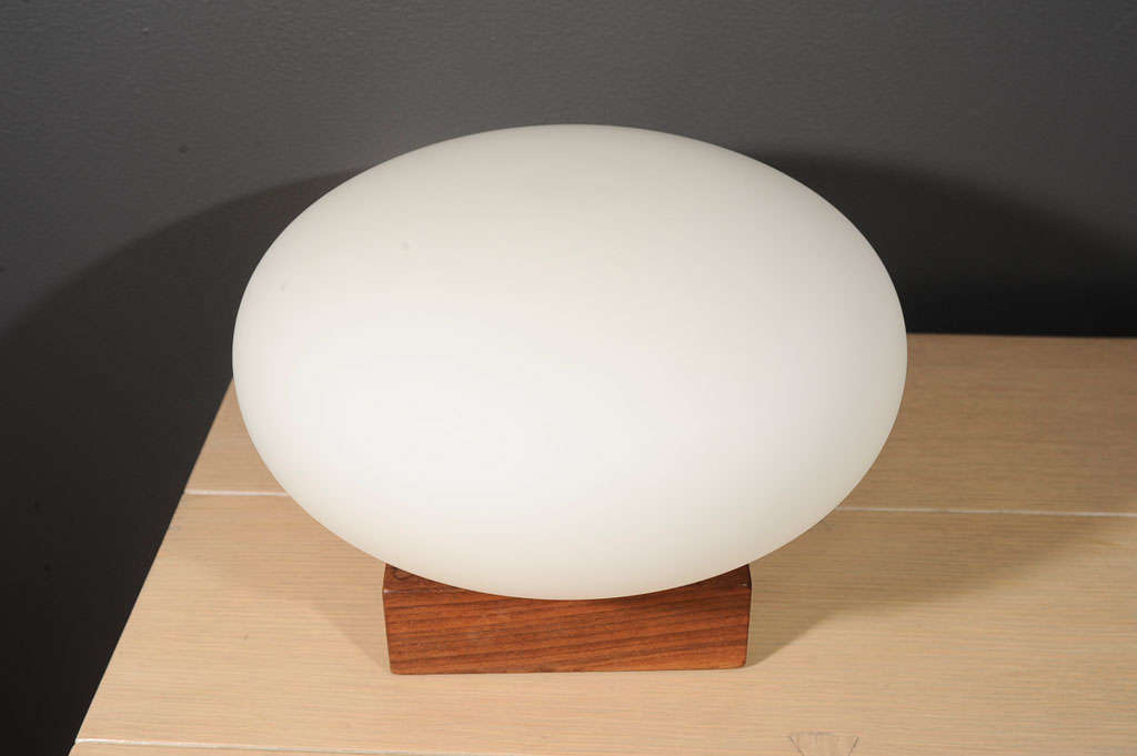 A mod Laurel-style bureau lamp consisting of a solid walnut block base and a frosted white blown glass shade that provides a wonderful, diffused glow. Ceramic socket. Clean, pleasing design, classic of the era.<br />
<br />
*Base = 6 x 6 x 1 7/8